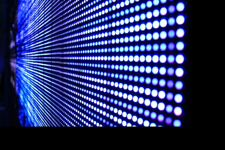 Bunte LED-Lichtinstallation mit blau-violetten Punkten in Linie angeordnet.