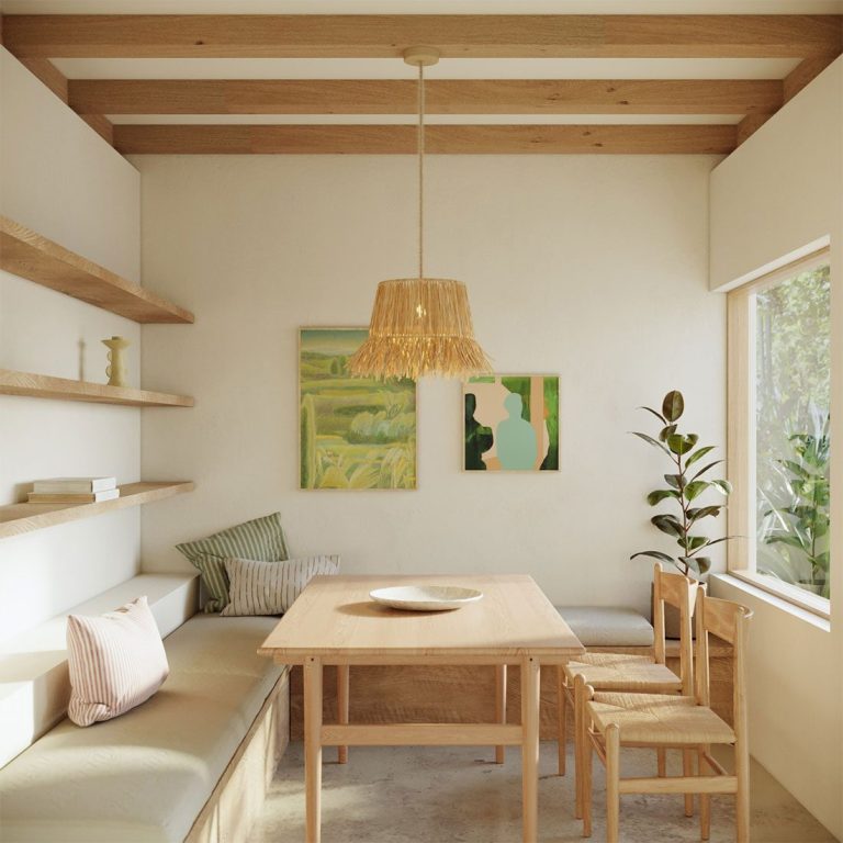 Helle Essküche mit Holzregalen, einem Tisch und zwei Gemälden an der Wand.