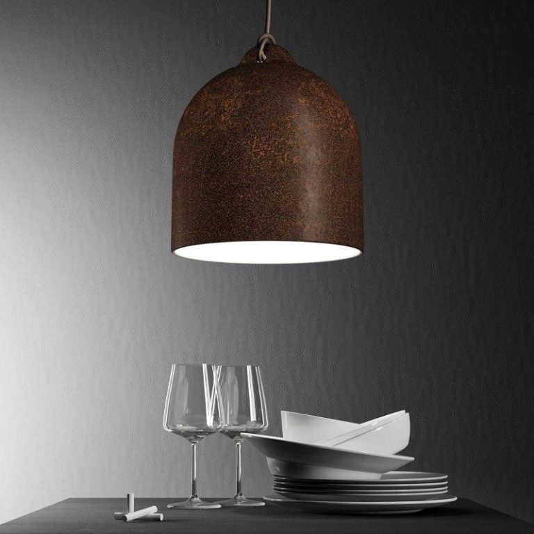 Eine rustikale Lampe hängt über einem Tisch mit Tellern und Gläsern.